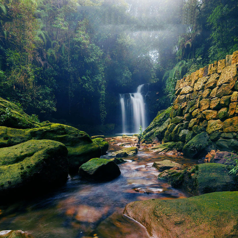 view of a waterfall amid hills