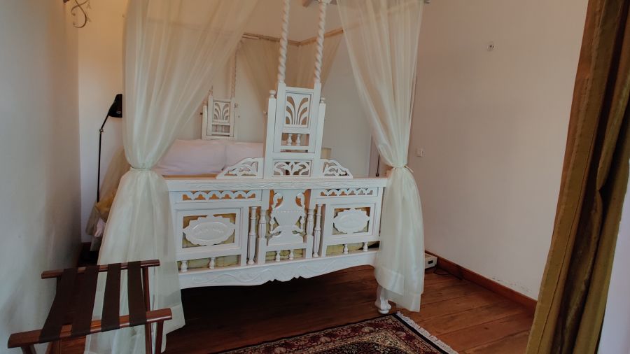Premium Room with intricate bedframe and side canopy at Te Aroha by Shervani Mukteshwar