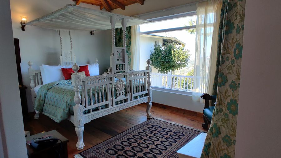  Superior Room with bed and a canopy above the bed at Te Aroha by Shervani Mukteshwar