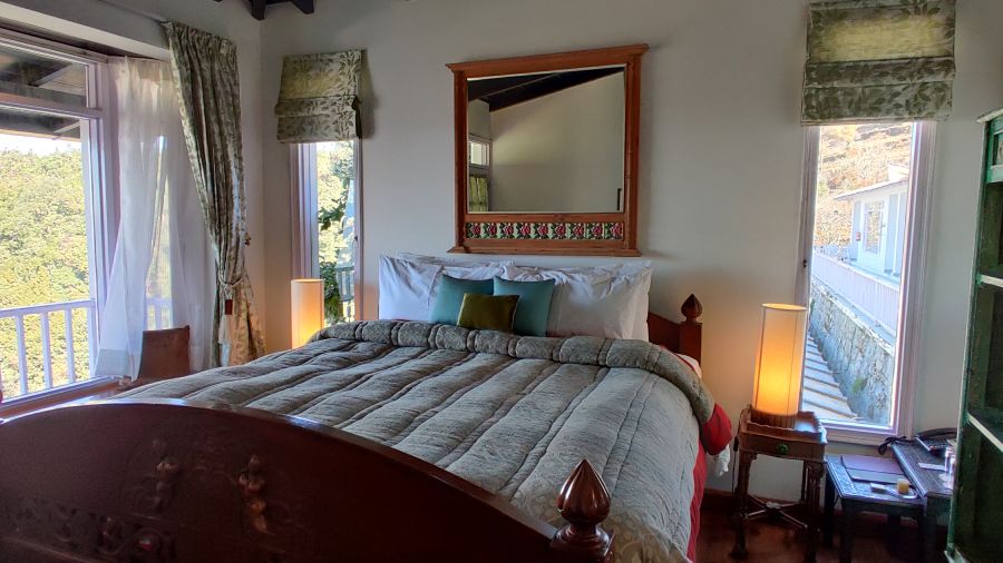 Premium Room with bed and lamp by the side of the bed at Bed with side canopy and a lamp on the side of the bed at 3 bhk cottage at Te Aroha by Shervani Mukteshwar