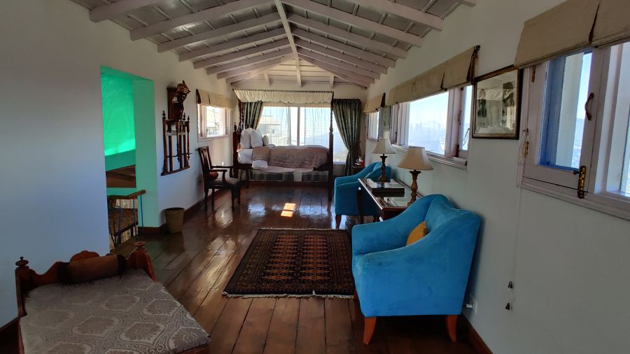 Suite Room with open side window and wooden flooring at Te Aroha By Shervani, Mukteshwar