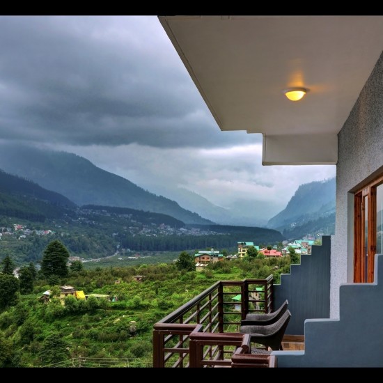 alt-text View of the mountains and town from  Summit Chandertal Regency Hotel & Spa