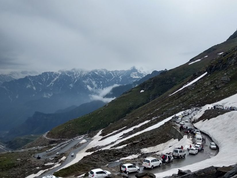 a road through a snow-covered mountains - The Orchid Manali