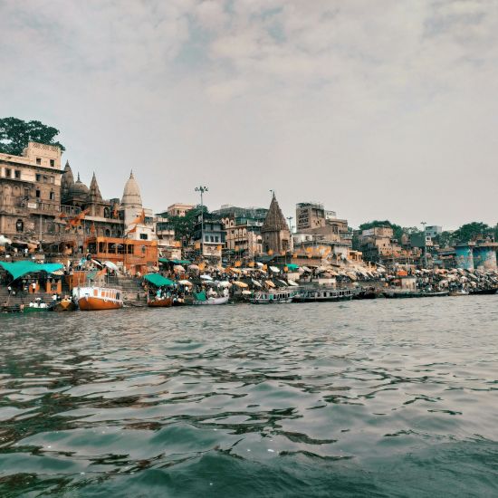 a wide shot of the holy Triveni Sangam along with the ghats 