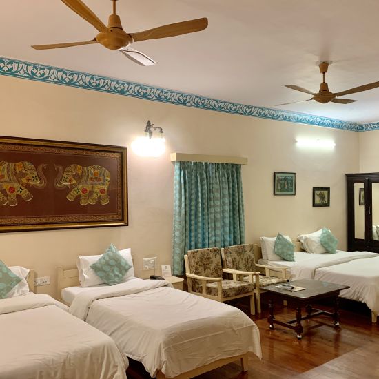 Two twin and one double bed at the family room at Suryaa Villa Jaipur