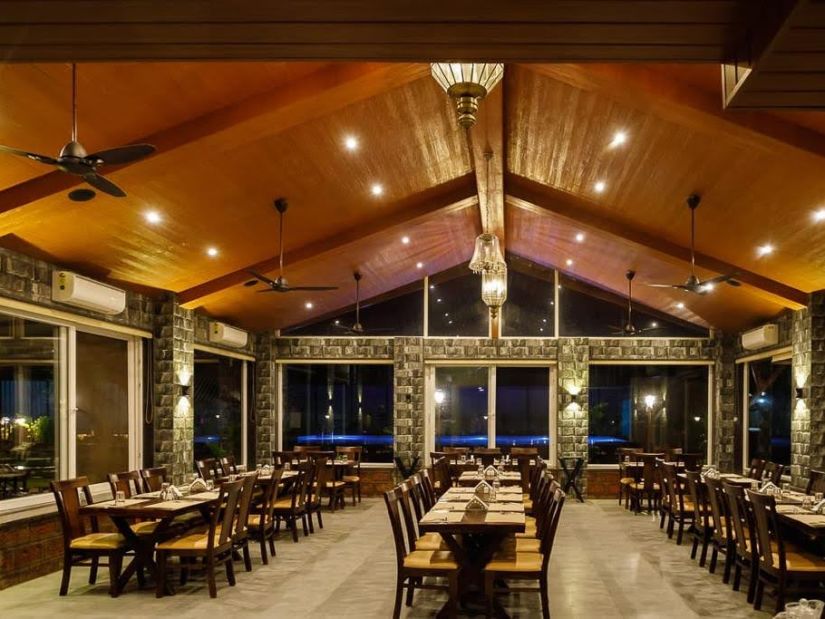 restaurant with tables and chairs - Mastiff Grand La Villae Resort, Lonavala