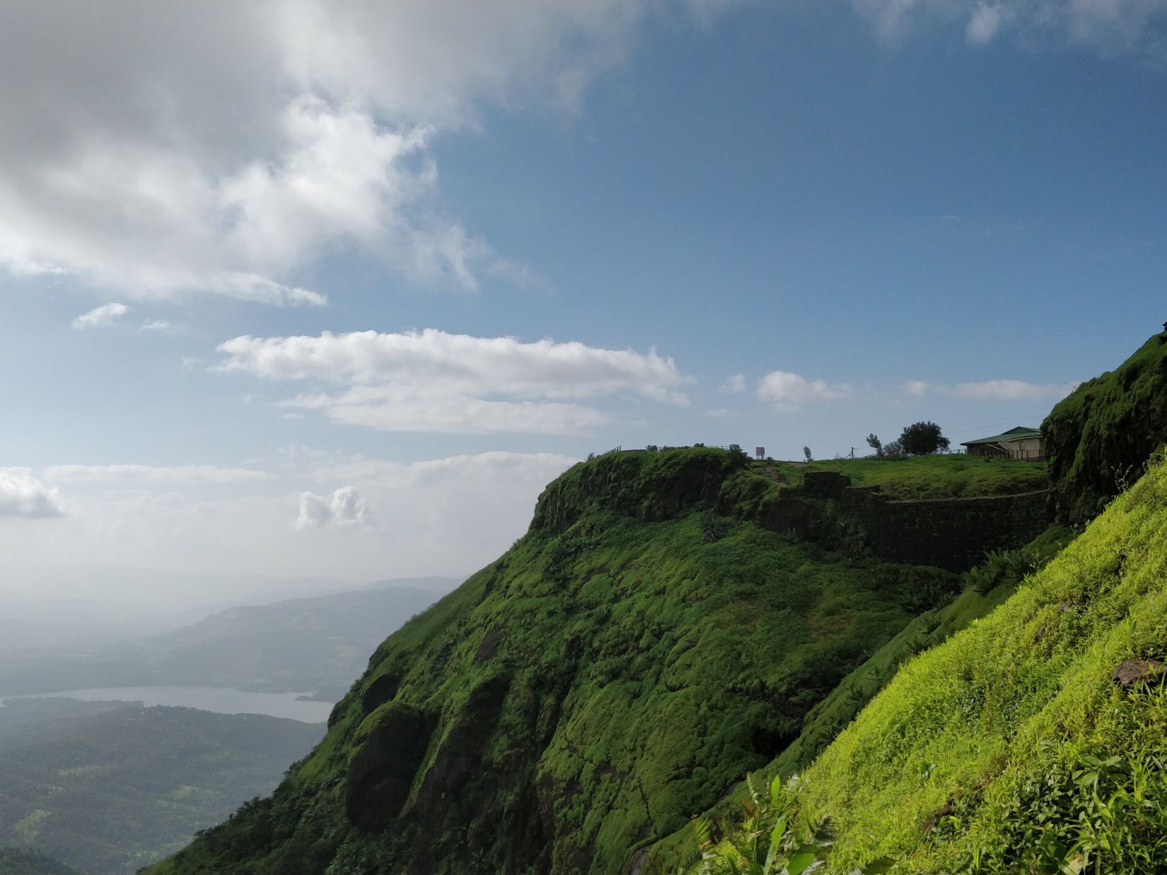 view of green valleys and hills covered in clouds 1