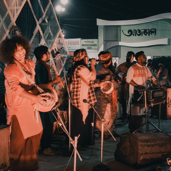 a band performing in a music festival with other people listening in - Polo Floatel Kolkata
