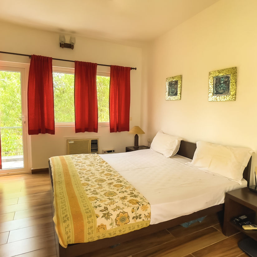 King bed with lamp on side table at el benito goa