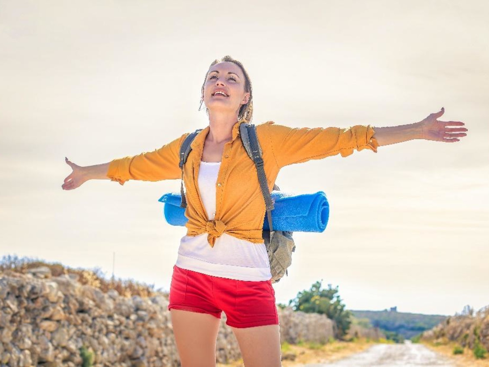 a woman standing with her arms open