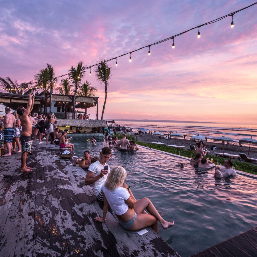 alt-text people enjoying by the swimming pool