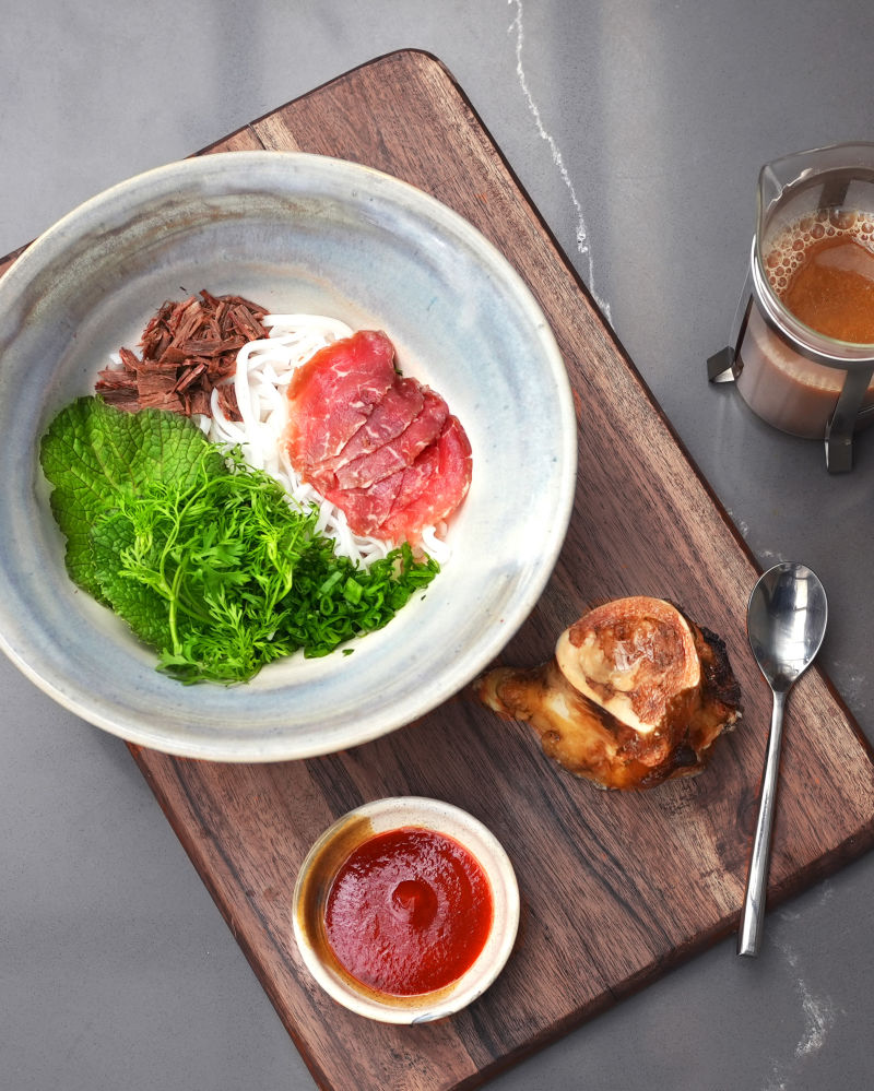 vietnamense pho on a serving board with accompaniments