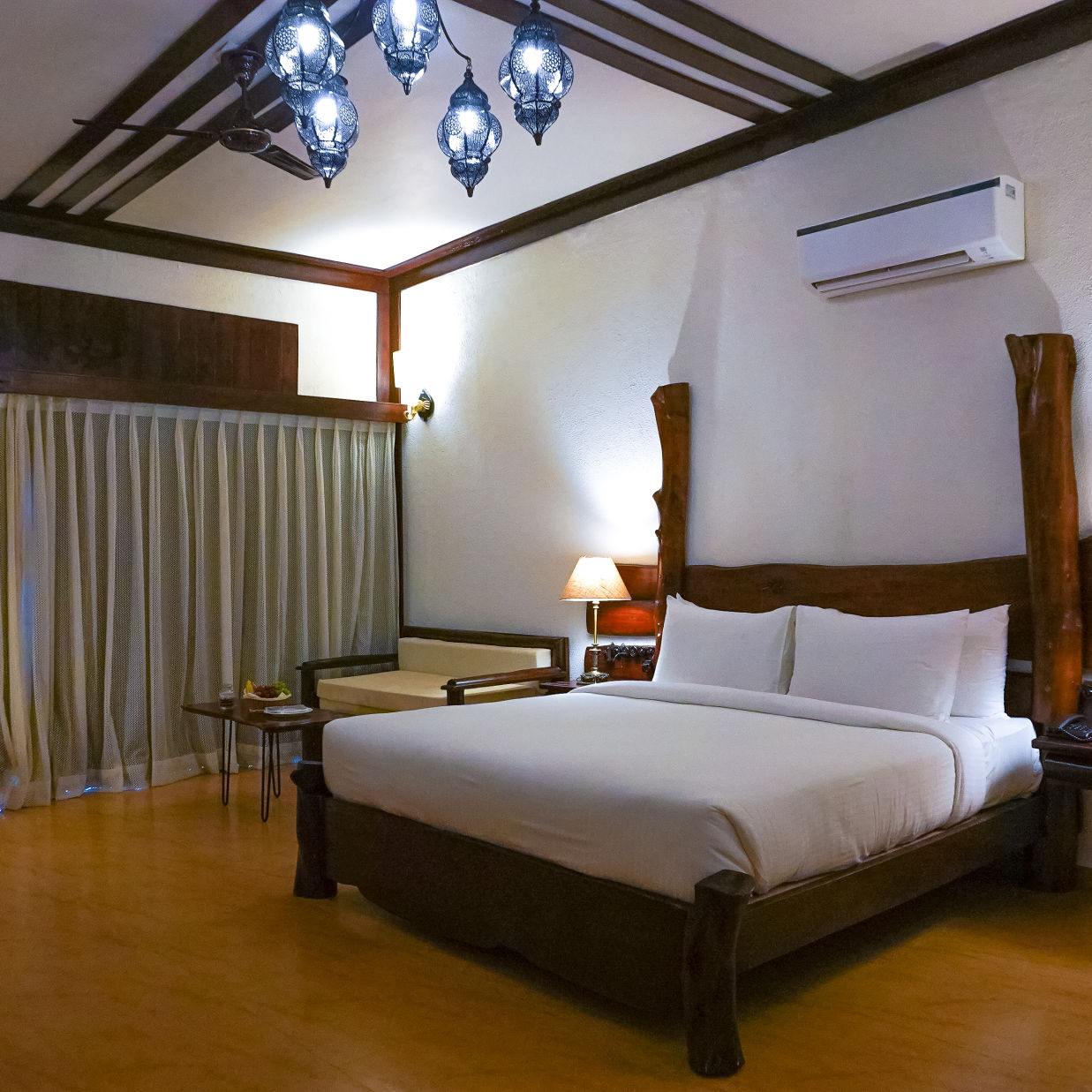 bedroom with white bed covers and other various other amenities at Jagira Ananta Elite 2