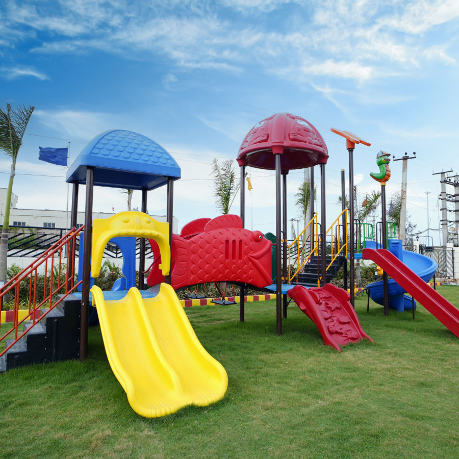 overview of the kids play ground with rides for kids on the grass - Shanti Seaview Resort & Spa