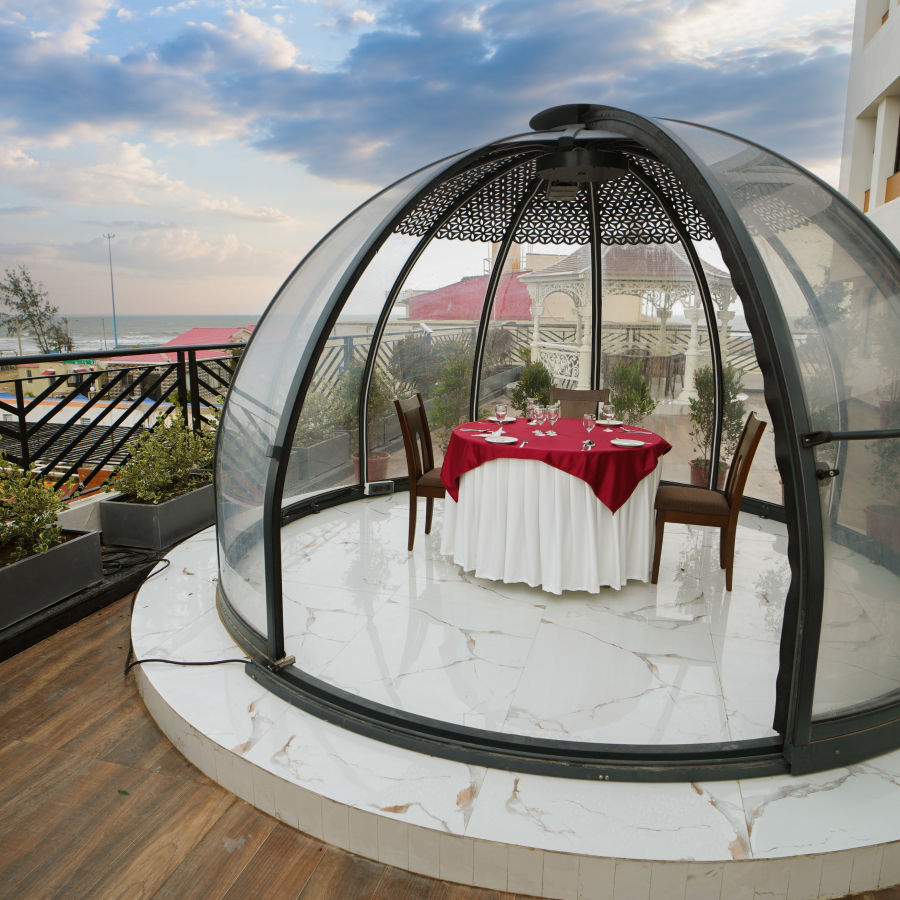 a half bubble kind of architecture with a table for two set inside it on the terrace - Shanti Seaview Resort & Spa - Hotels in Mandarmani Sea Facing