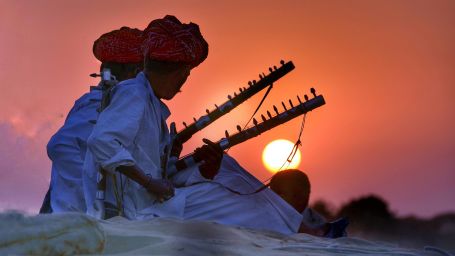 Rajasthani men with turbans holding a musical instrument