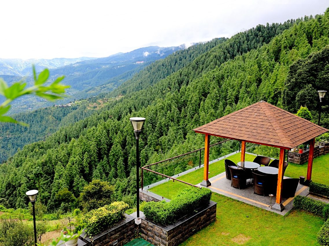 outdoor sitting area at Aranya surrounded by greenery - Aranya Himalayan Retreat, Mashobra