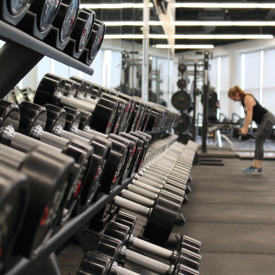 Gym equipment in the gym and people working out