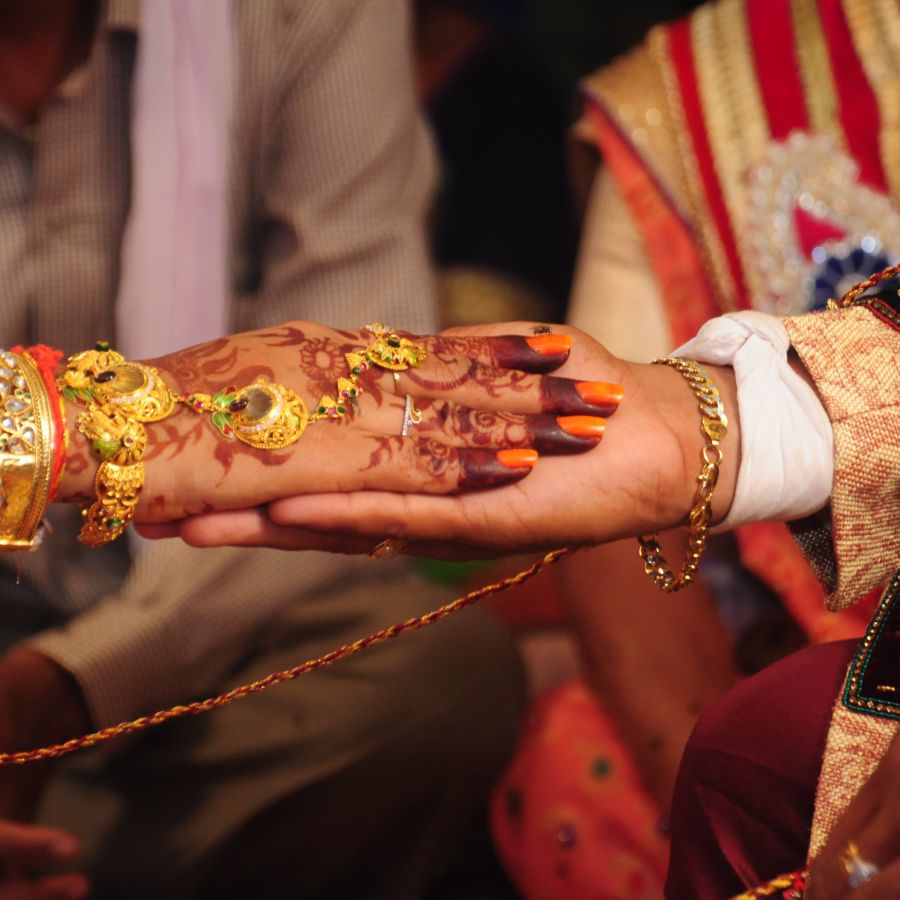 alt-text bride and groom holding hands during a wedding ritual