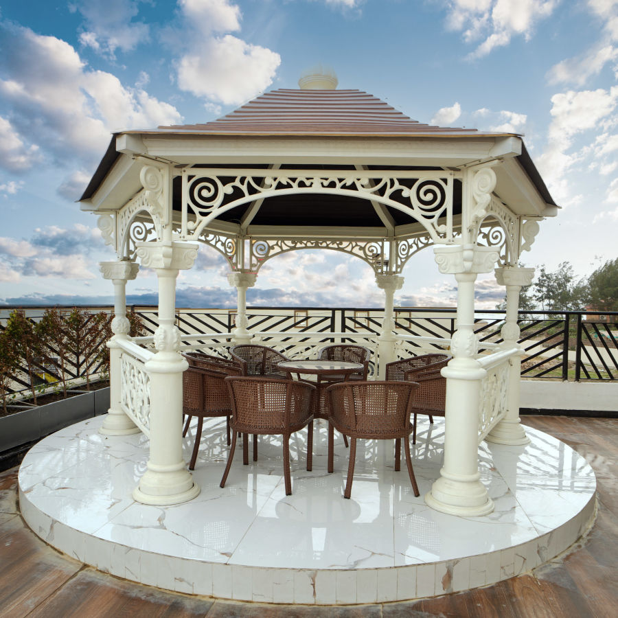 A canopy with seats inside it on the terrace with wooden floor board on the terrace - Shanti Seaview Resort & Spa