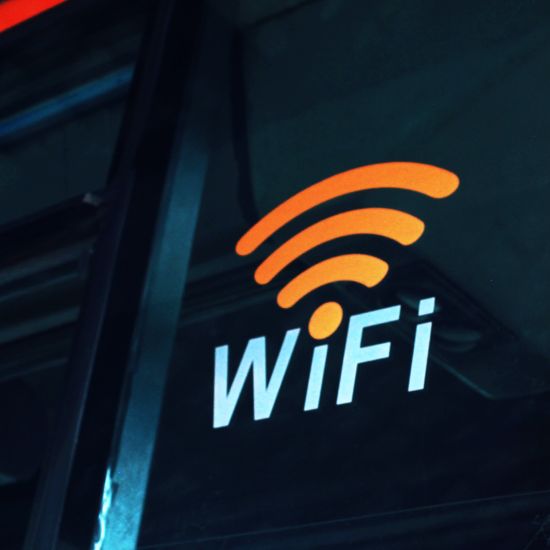 A wi-fi symbol with the words wifi on a bus placed on a plastic exterior