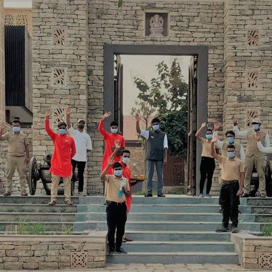 Aramness staff waving at the entrance gate