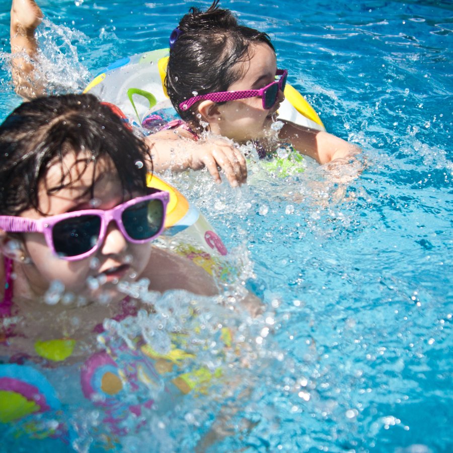 alt-text 2 toddlers with sunglasses on in a swimming pool