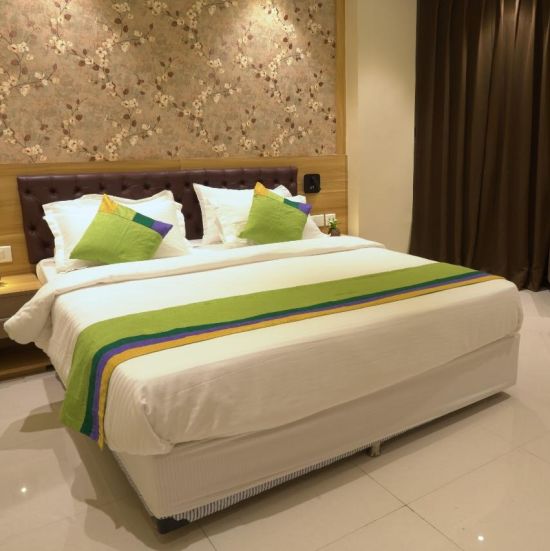 a view of premium room with a sofa placed by its side - Click Hotel Capital House, Patna