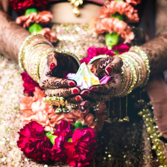 alt-text bride in a beautiful pink and gold attire