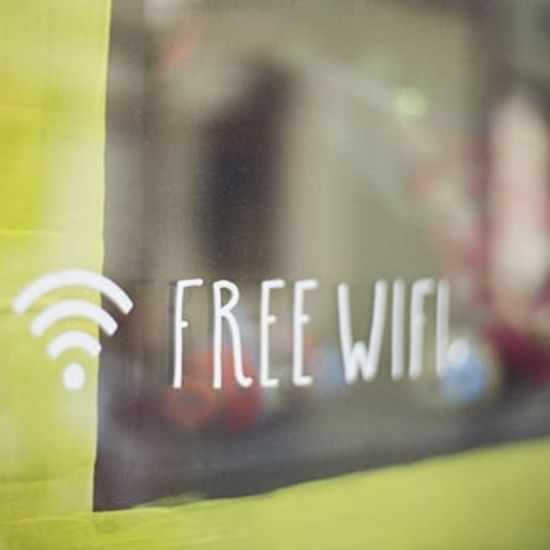 a sign on a glass saying free wifi with the logo of wifi