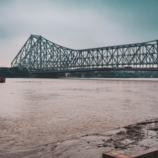 view of howrah bridge and river hooghly flowing under it