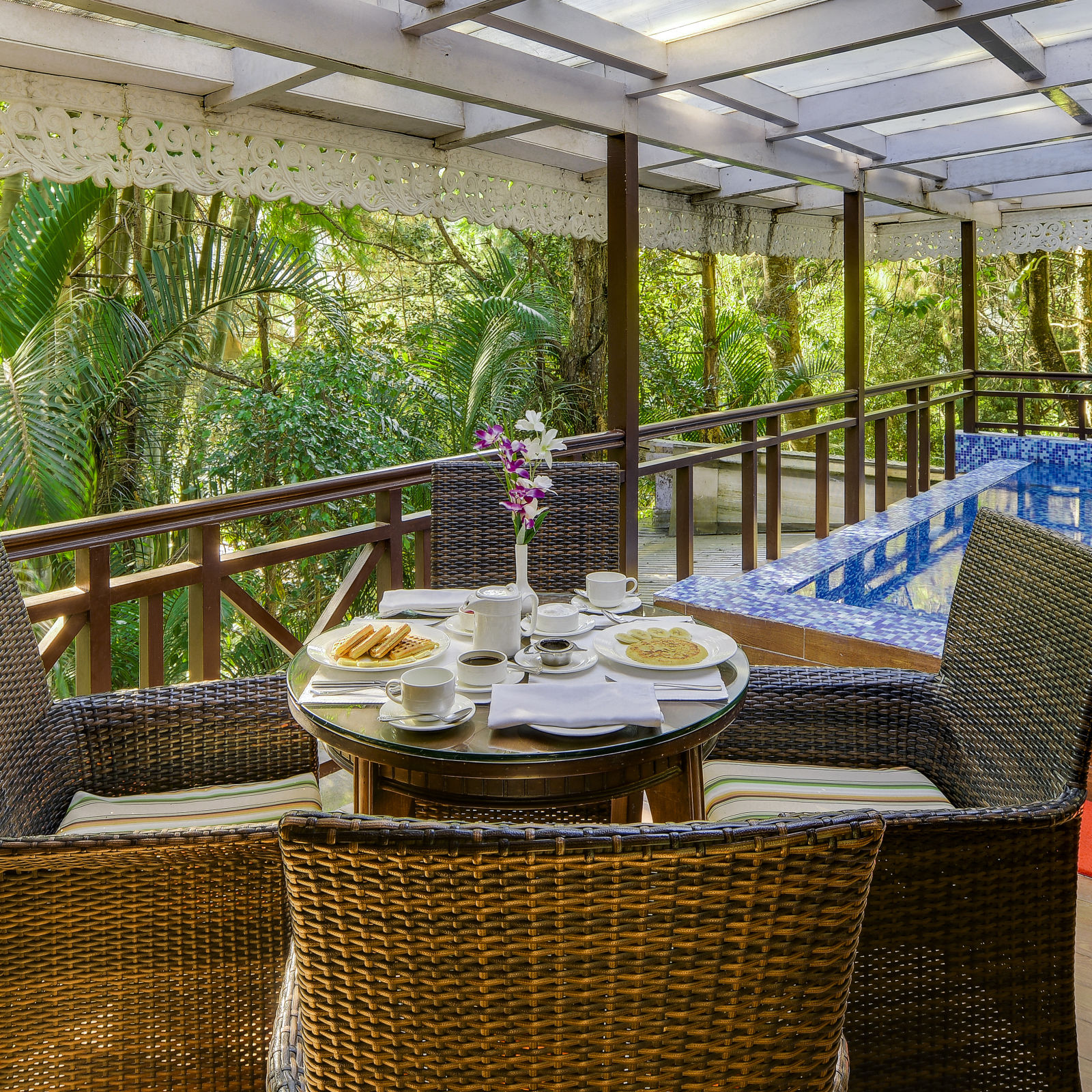 the outside dining seating space by a private pool attached with a room - Best multi cuisine restaurant ‘Orchid’ in Mayfair - Mayfair Spa Resort & Casino Gangtok