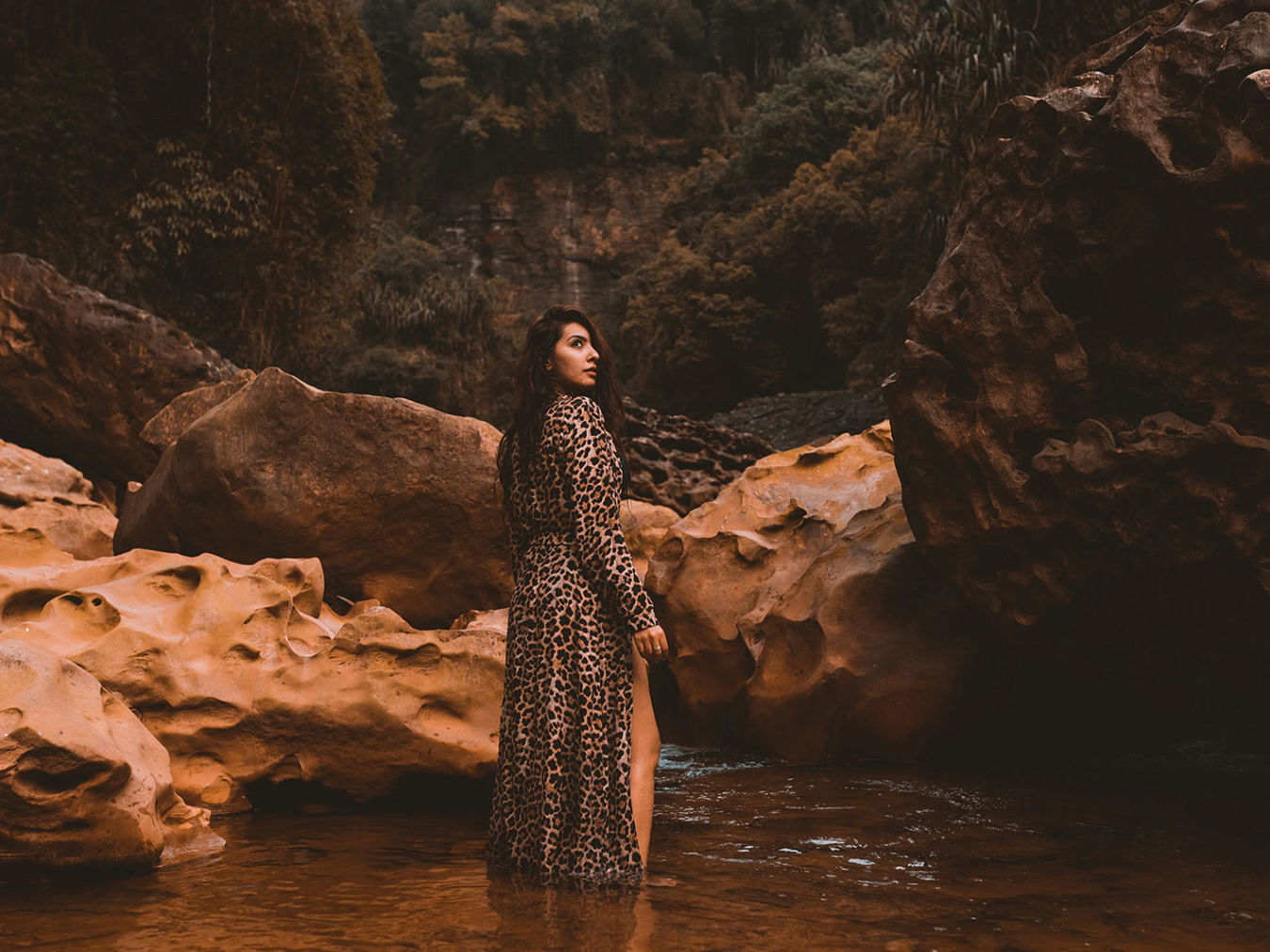 person posing by a water body