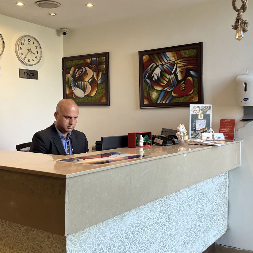 the reception desk at yuhi mansions shot from different angles showcasing a staff working while wearing a suite2