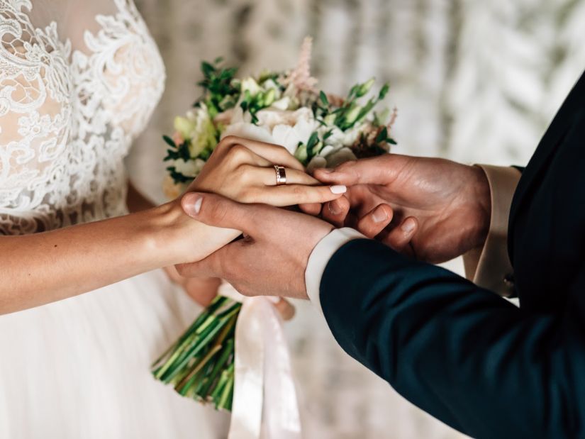 a couple exchanging wedding rings