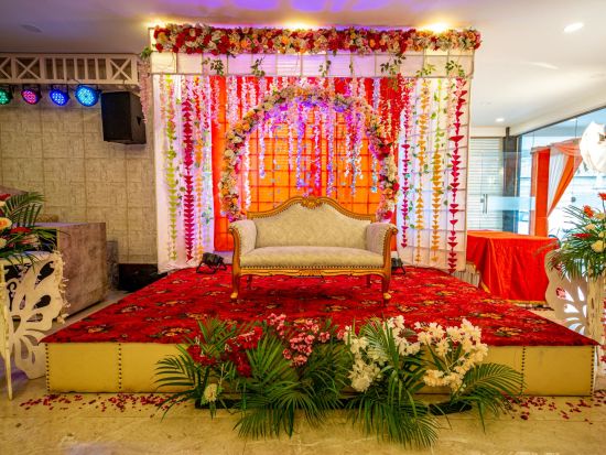 A front view of a stage decorated with flowers | Sun Park Hotel & Banquet, Chandigarh - Zirakpur