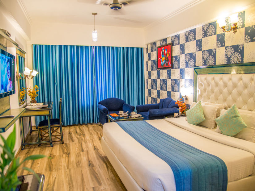 A side view of a room with a bed and TV | Sun Park Hotel & Banquet, Chandigarh - Zirakpur