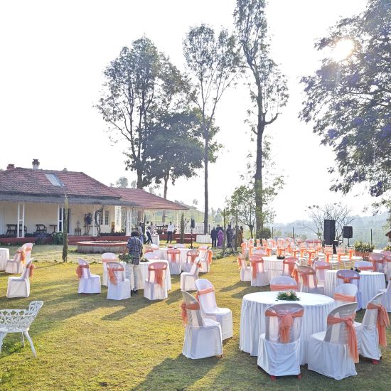 alt-text View of an outdoor wedding venue set against a backdrop of lush greenery and hills in Coonoor.