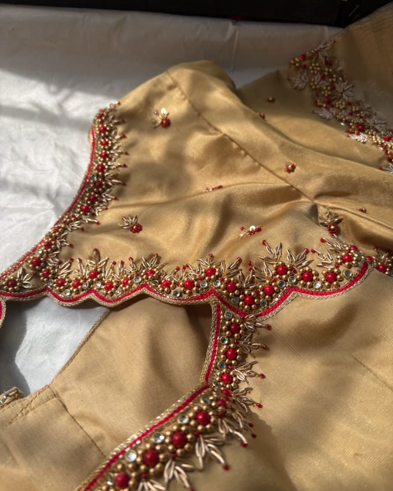 Gold bridal blouse neckline with red and gold beadwork, by SIRA