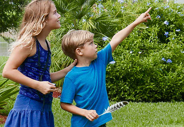 A young girl and a young boy outside