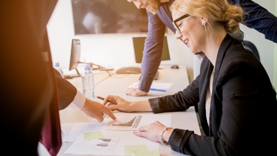 Smiling Young Business Woman Looking At A Business Chart