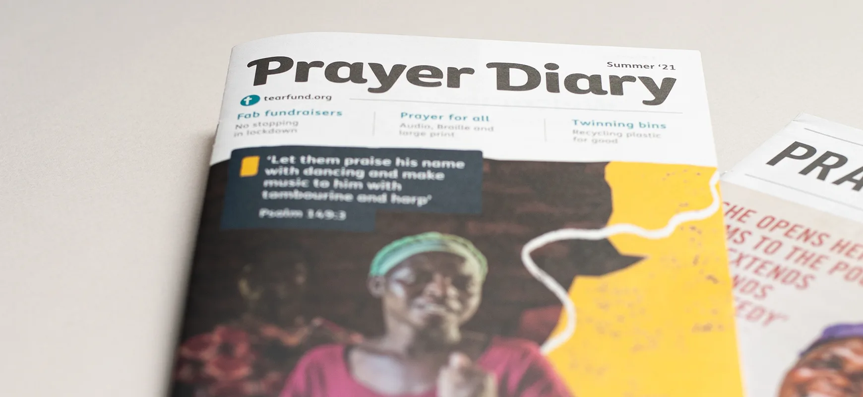 Prayer Diary front cover, with a previous issue in the background.