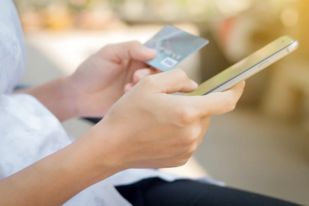 someone using credit card to pay something on phone