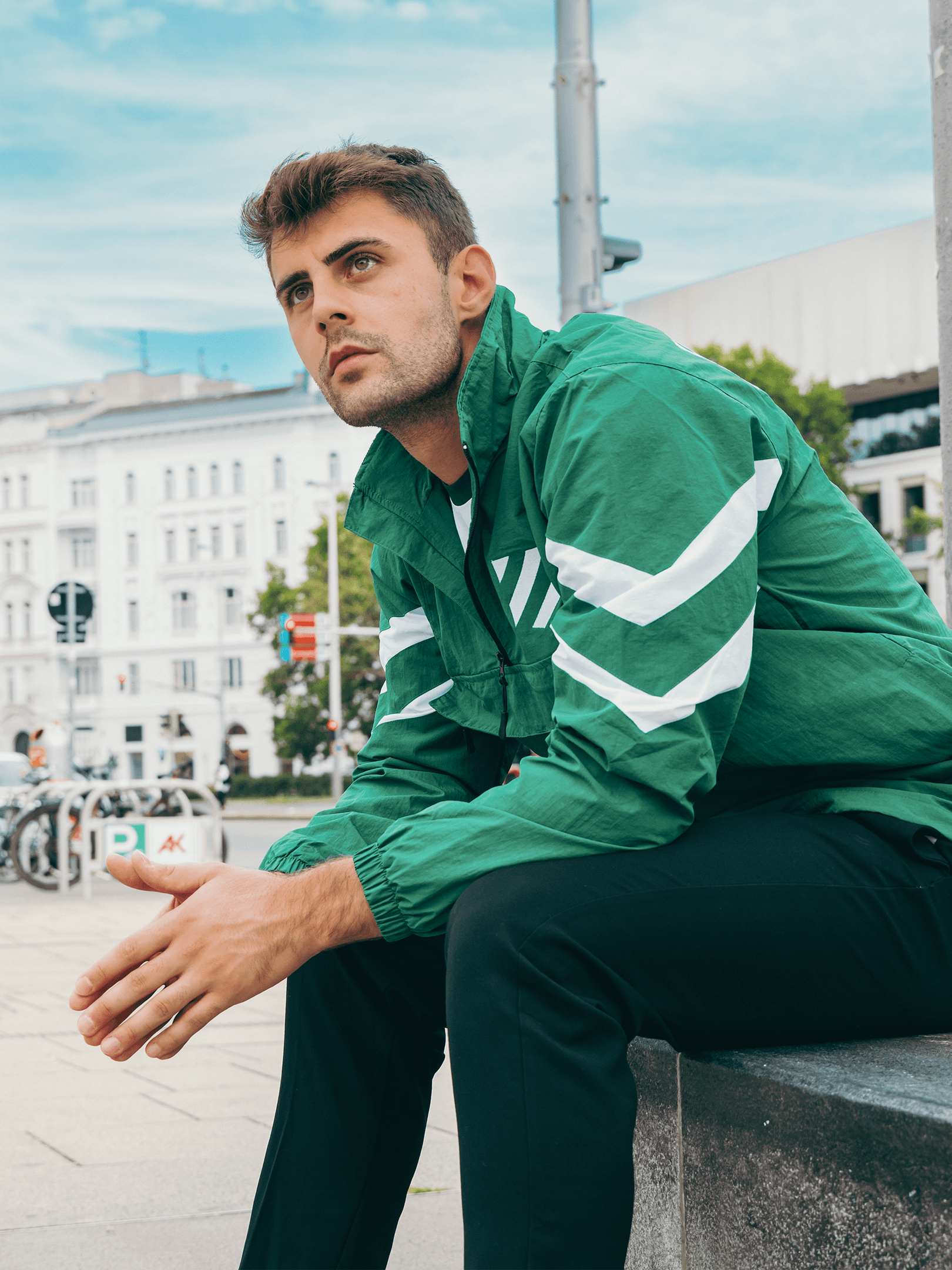 Grüner SK Rapid Windbreaker Wappenschild mit weißen Ärmelstreifen in Lifestyle-Aufnahme.