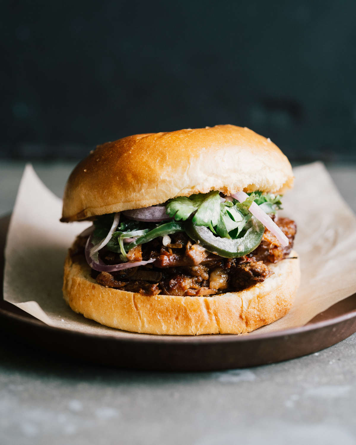 Tender beef brisket sandwich with avocado and jalapeño sauce