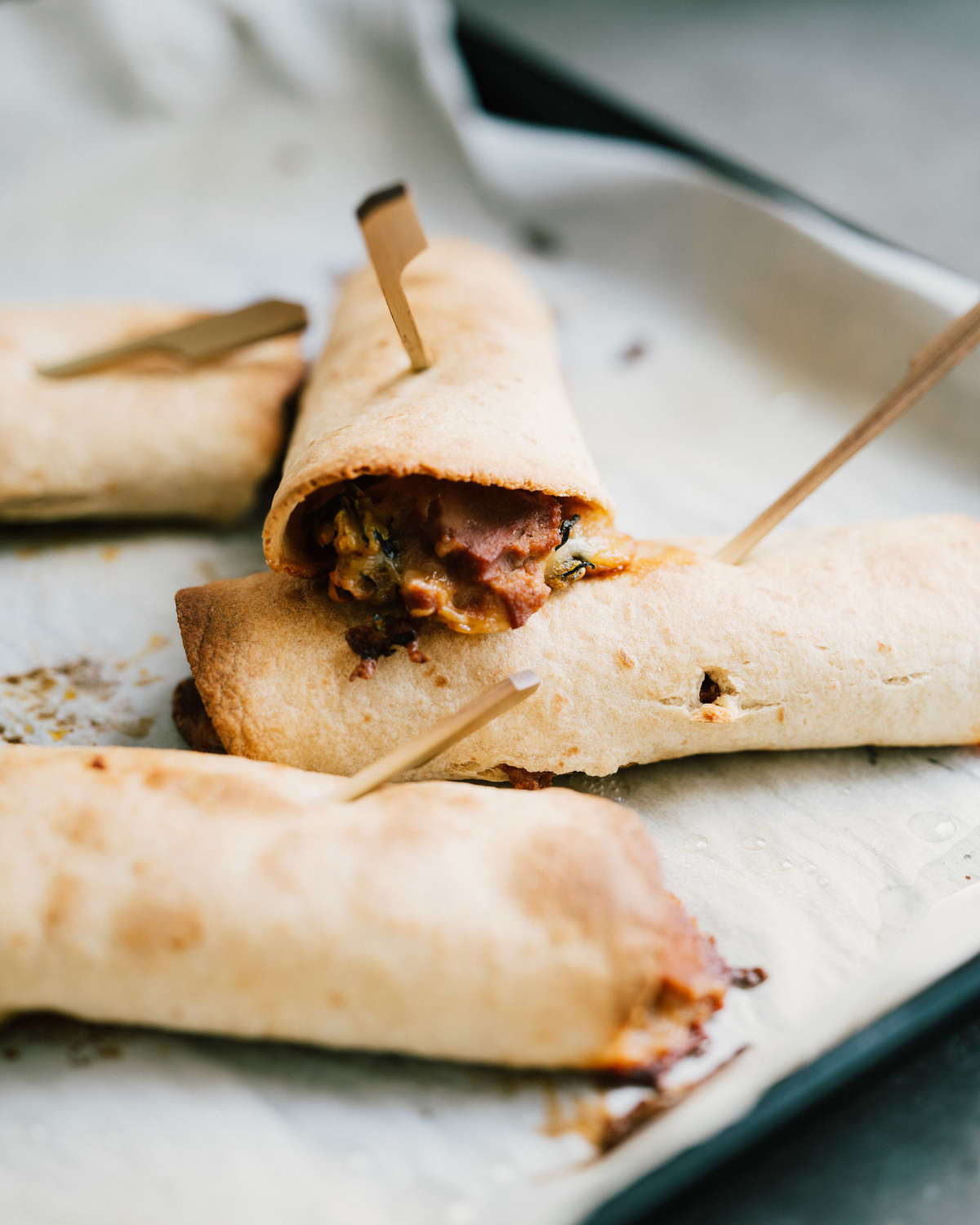 Baked Zucchini Taquitos w/ Spicy Avo Sauce