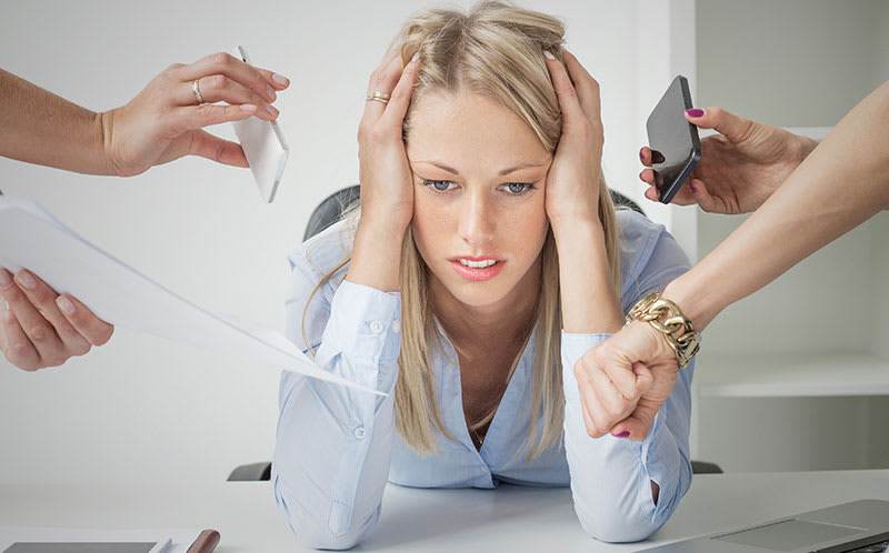 Businesswoman surrounded by stressors