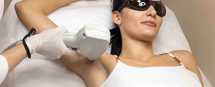 Woman getting laser hair removal on her armpits