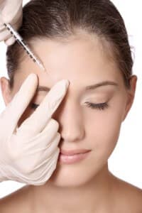 woman getting injection in her forehead