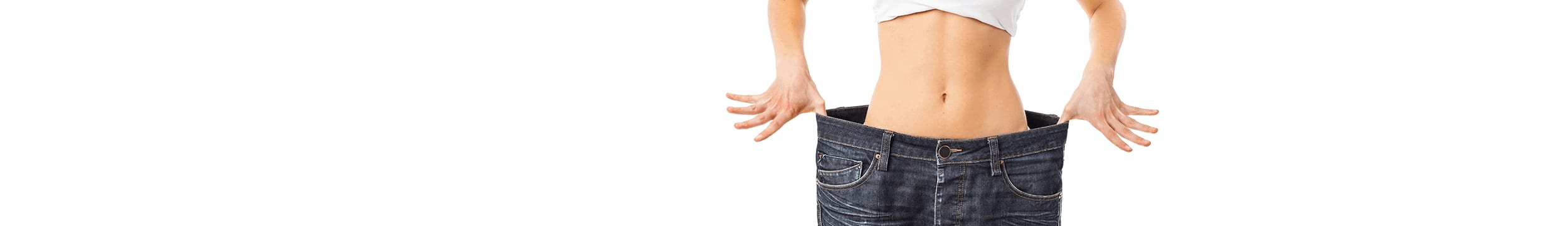 woman wearing white tank top and baggy jeans showing weight loss